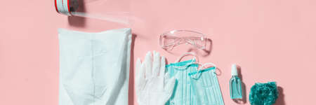 Folding medical protective clothing uniform, masks, glasses and sanitiser on cbackground. Stop coronavirus. Finished pandemic crisis. End quarantine. Victory over covid-19. Mask off.の写真素材