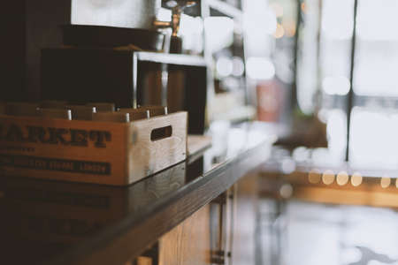 Wooden box with cups. Detail of interior of cafe and restaurant. Empty. Copy space. Defocused background. Equipment. Self service placeの写真素材