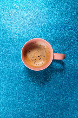 One cup hot fresh coffee on brilliant blue color paper. food background. top view. flat lay. minimalismの写真素材