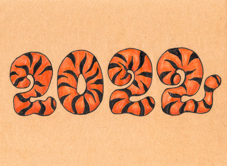 Numbers 2022 orange with black stripes year of the tiger drawn on craft paperの写真素材