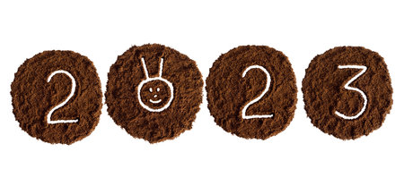New year 2023 from coffee drawn on a white background from ground coffee, year of the rabbitの写真素材
