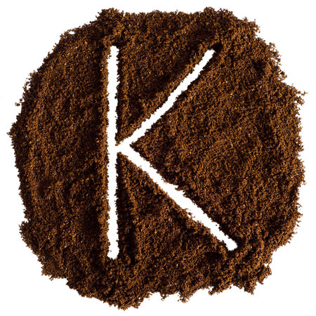Coffee powder in the shape of the letter K on a white backgroundの写真素材