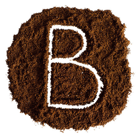 B written in ground coffee, isolated on white background. top view.の写真素材