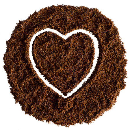 Heart made of ground coffee isolated on a white background. Symbol of love.の写真素材