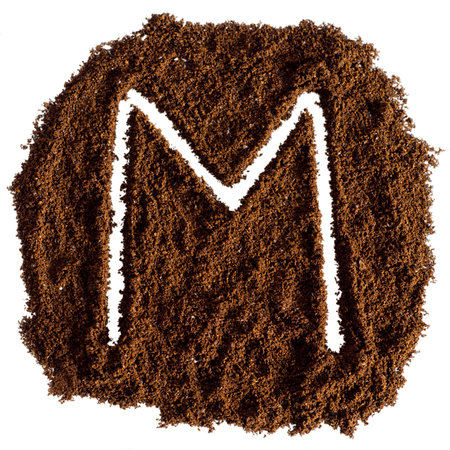coffee powder alphabet isolated on white background, letter M. Top view.の写真素材