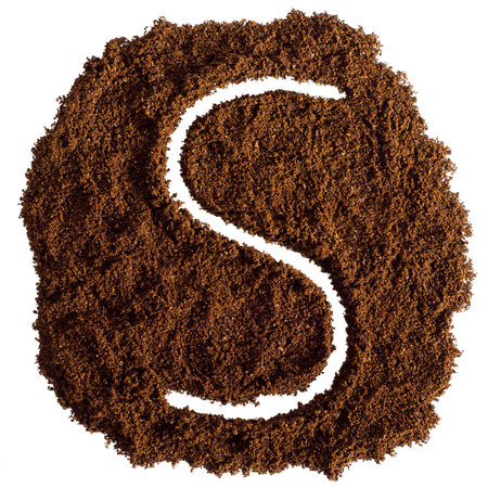 S letter from ground coffee isolated on white background. top view.の写真素材