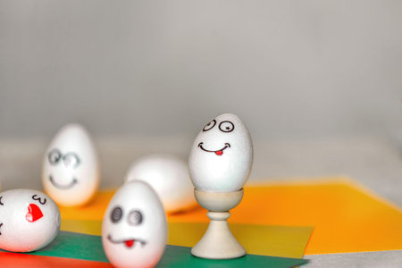 stickers with different emotions are pasted on white eggs, copy space .the concept of communication...