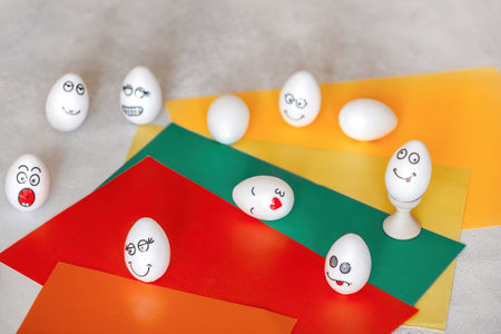 stickers with different emotions pasted on white eggs. the concept of communication and emotions in social networks, an unusual decoration of Easter eggsの写真素材
