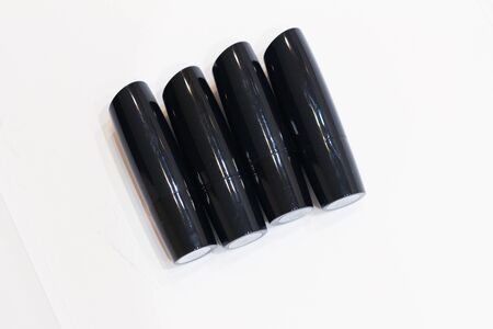 tubes of black lipsticks on a white backgroundの写真素材