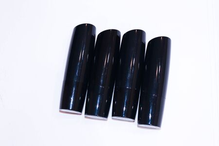 tubes of black lipsticks on a white backgroundの写真素材