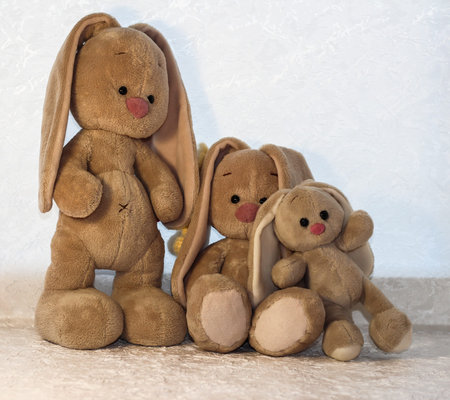 Bunnies on a white background. Plush rabbit toy.