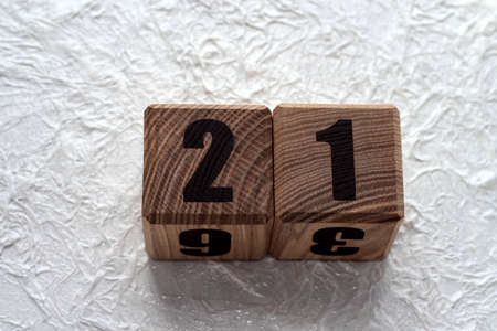 Wooden cubes with numbers on a white crumpled background. 21.の写真素材