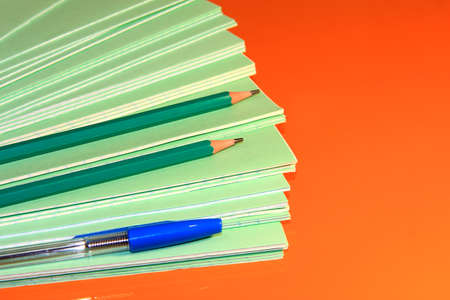 A stack of school green notebooks on a bright background.の写真素材