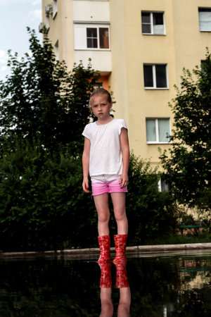 A girl walks in a large puddle. The Donetsk Petrovsky district 07/05/2020のeditorial素材