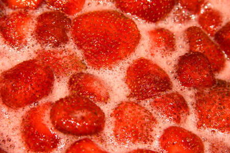 Strawberry jam is being made. A seething mass with berries.の写真素材