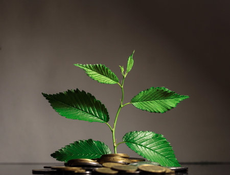 A green sprout from a pile of kopecks. Savings. Symbol of revenue growth. Ukrainian currency.
