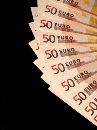 A fan of 50 Euro bills on a black background. Stable currency. Currency of the future.