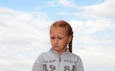 Girl against the sky. A little girl with pigtails against the sky. Children Of Donbass.