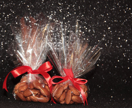 Two bags of almonds on a black background.の写真素材