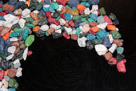 Crescent of colored candies on a black background