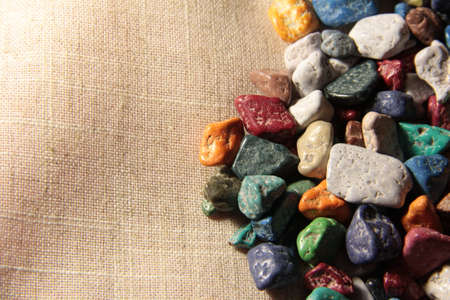 Sweet stones on the right on a beige background. Green, orange, pink, white candies.の写真素材