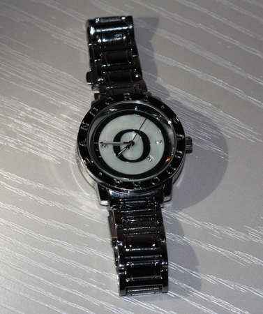 Women's silver watch on white wood. Stylish watchの写真素材