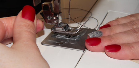 Thread a needle on a sewing machine.