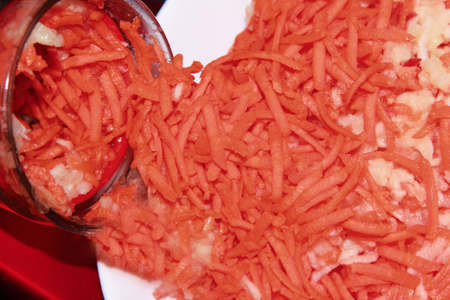 Grated carrot with Apple on a blenderの写真素材