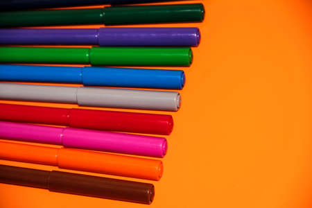 Markers on the orange tableの写真素材