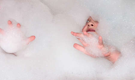 Drowned in a bubble bath. Get wet and have fun.の写真素材
