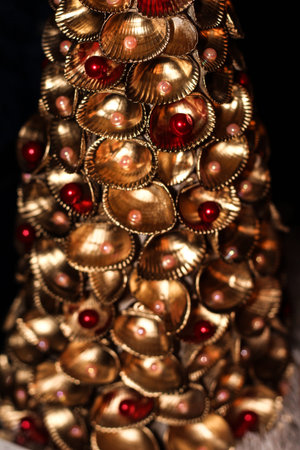 handmade Golden Christmas tree with beads made from sea shellsの写真素材