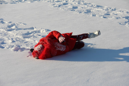 child lying in the snow