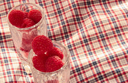 Berries in a crystal bowl on a checkered background.
