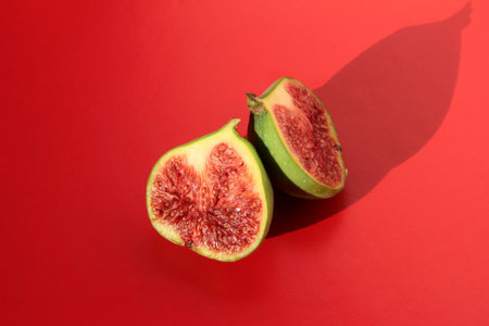 Fig slices on a red background. Figs with shadows.