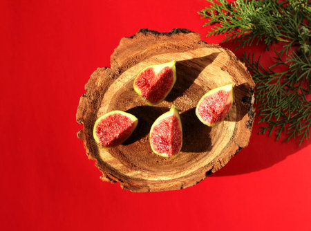 Figs with red flesh on a wooden background. Fruit on the stump.