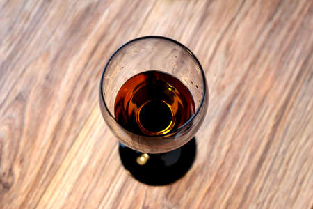 Glass of wine on a wooden background.の写真素材