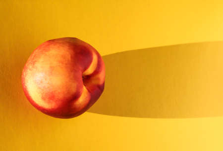 Nectarine on a yellow background. Fruit on a bright background.の写真素材