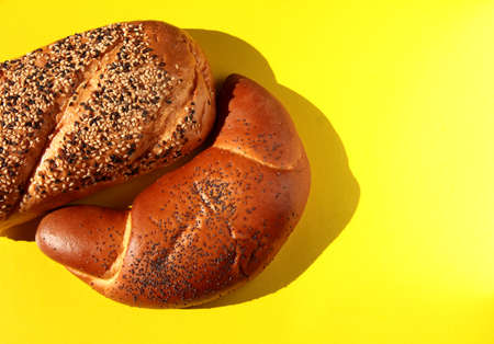 Bakery products on a yellow background. Bread with sesame and flax.の写真素材