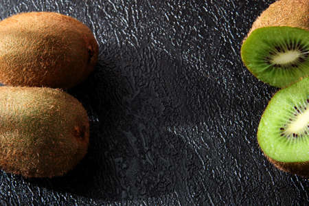 Kiwi on a black textured background. Juicy fruit.の写真素材