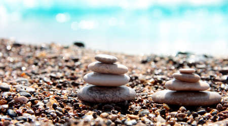Sea pebbles on the background of the azure sea coast. Sea background. Relax. Pyramidの写真素材