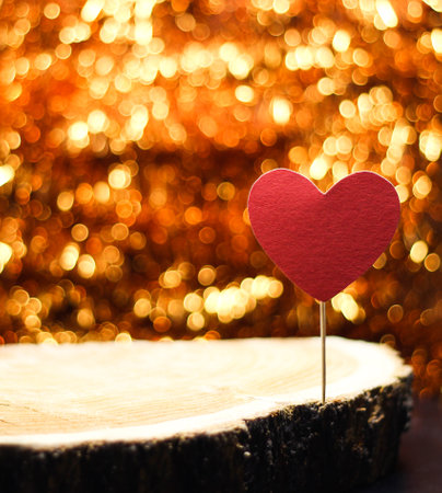 Heart on a stick on a background with Golden bokeh.の写真素材