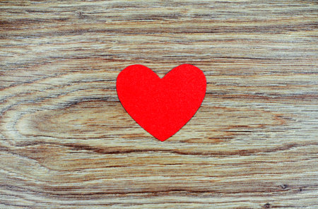 Red heart on a wooden background. Valentine