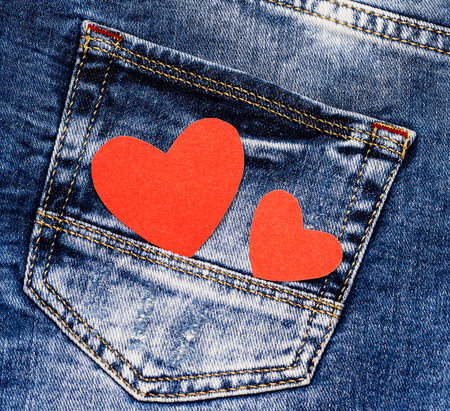 Red hearts on denim. Love symbol. Valentine's card.の写真素材