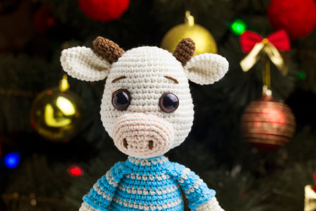Knitted toy bull on a Christmas background.の写真素材