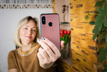 The girl is broadcasting live on the phone.