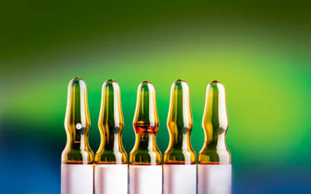 Medical ampoules on a blue-green blurred background.の写真素材