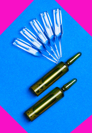 Medical ampoules on a blue textured background.