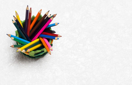 Colored pencils on a white textured background.