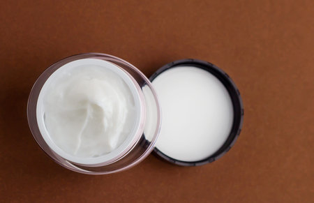 Jar of cosmetic cream on a brown background.の写真素材