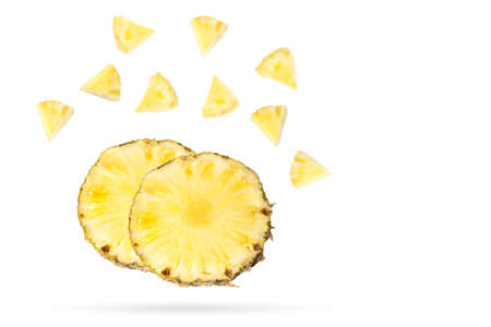 Flying pineapple slices. Levitation of fruit on a white background.の写真素材